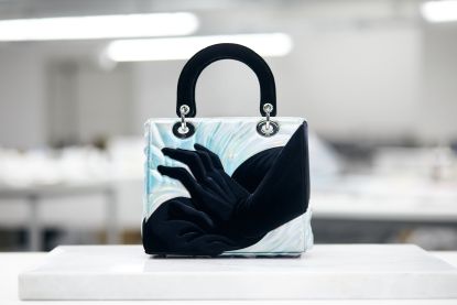 Lady Dior handbag by Alex Gardner with painting of hands on it